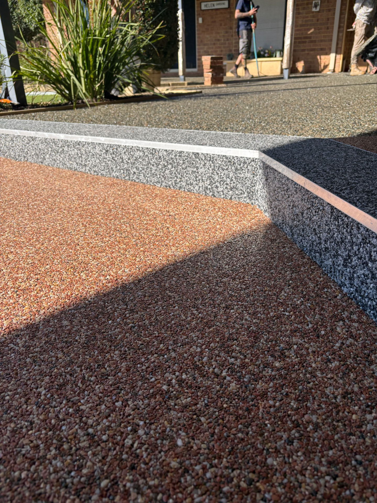 Group of trainees learning resin bound installation at Vuba Surfaces WA training in Perth
