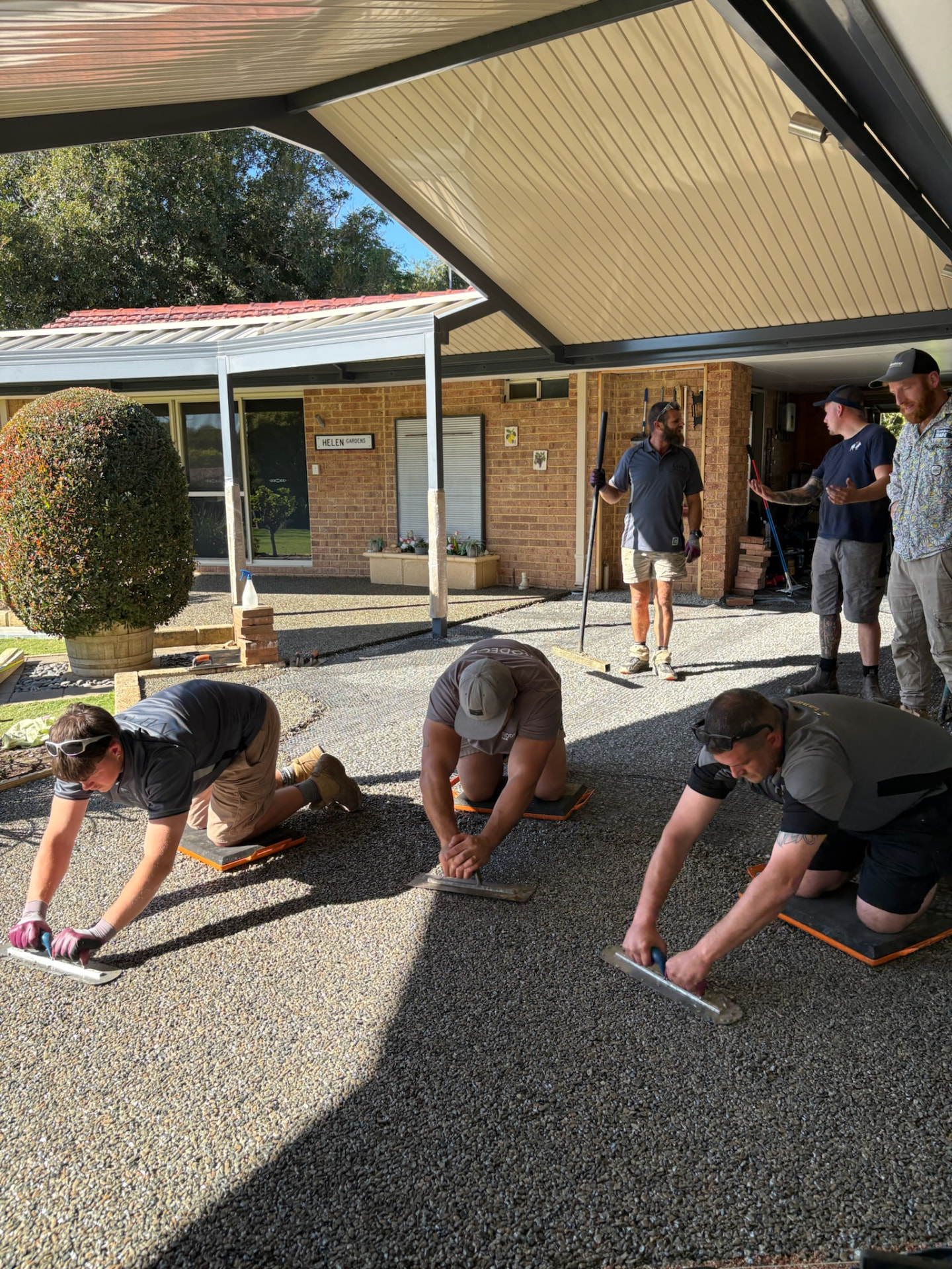 Training group trowelling resin bound driveway together