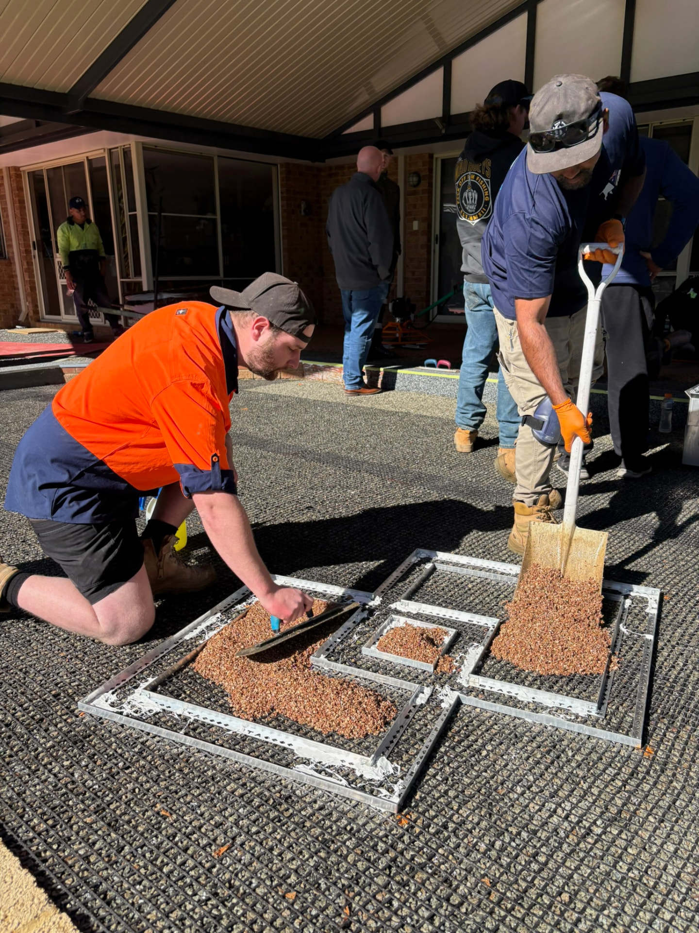 Trainee installer troweling a resin bound surface at a Vuba training session in Perth