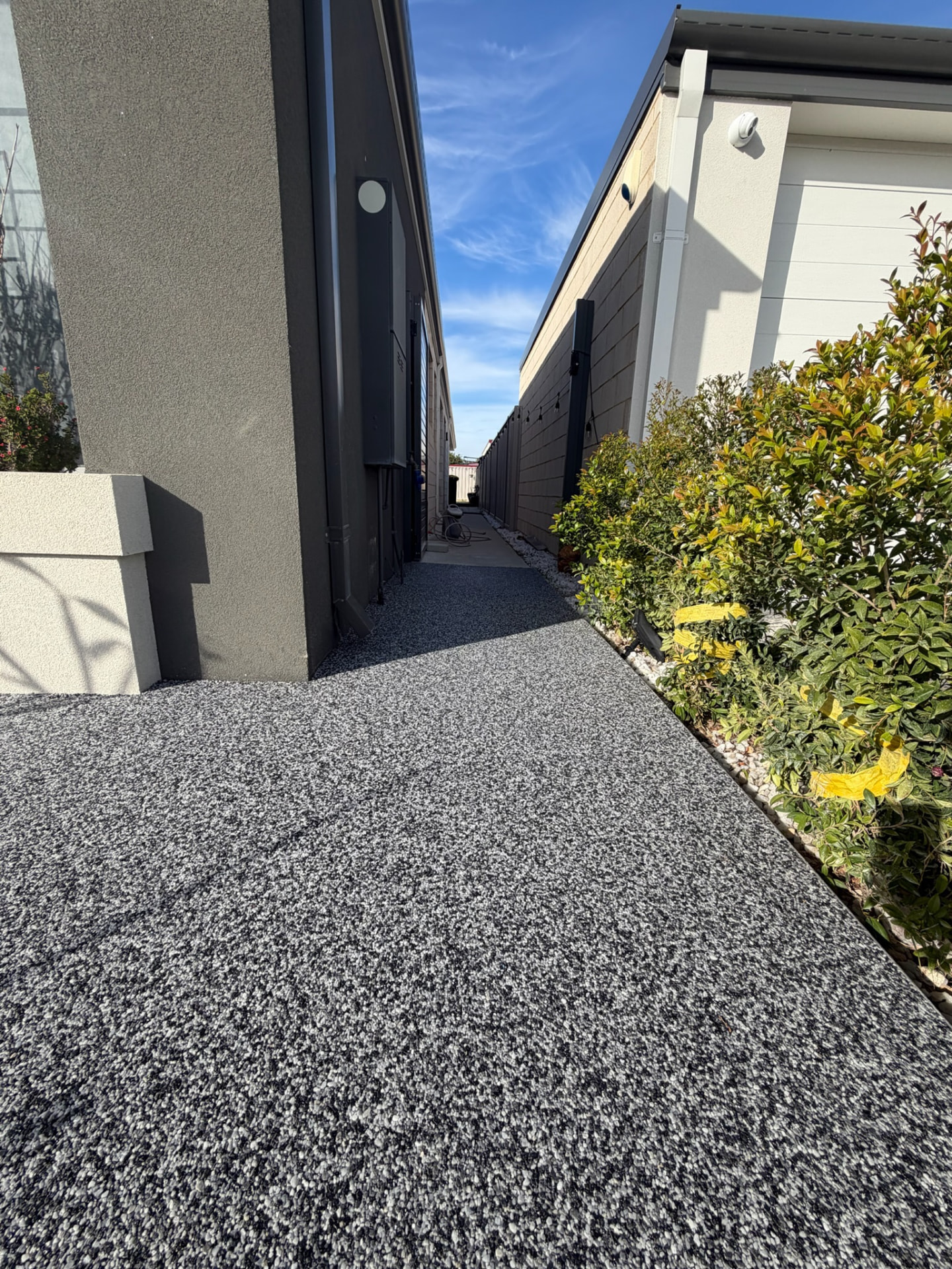 Grey resin bound side pathway Perth alongside modern home
