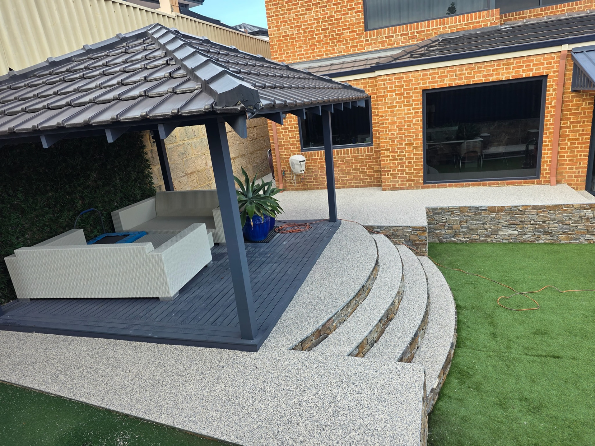 Resin bound curved steps and patio Perth with stone risers