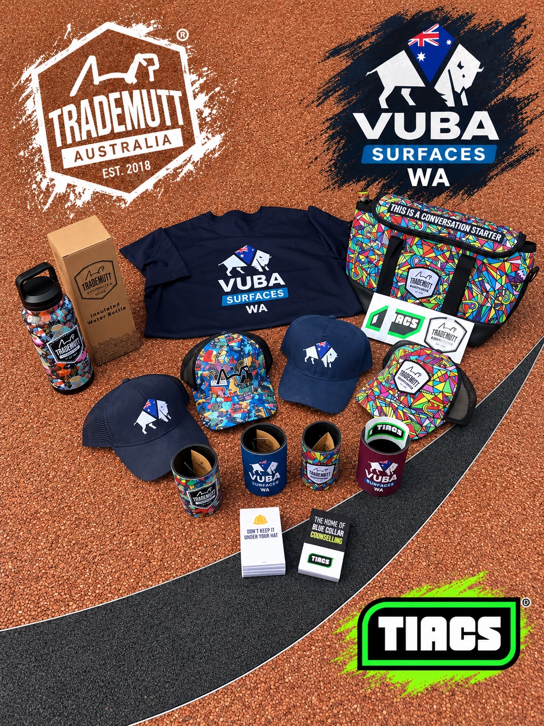Overhead flat lay of TradeMutt and Vuba Surfaces workwear including a shirt, caps, bottles, stubby holders and TIACS cards