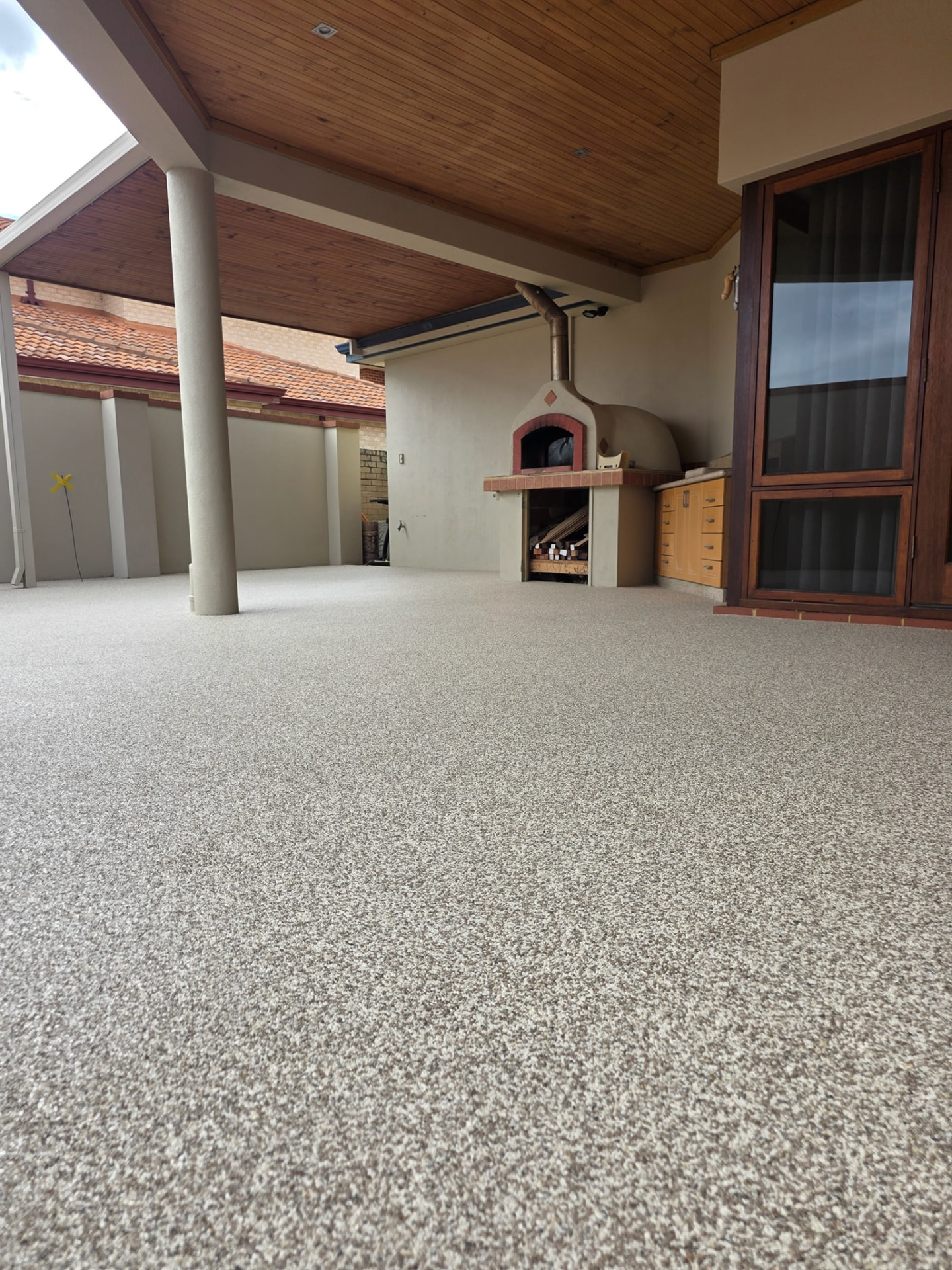 Resin bound undercover alfresco patio Perth with pizza oven