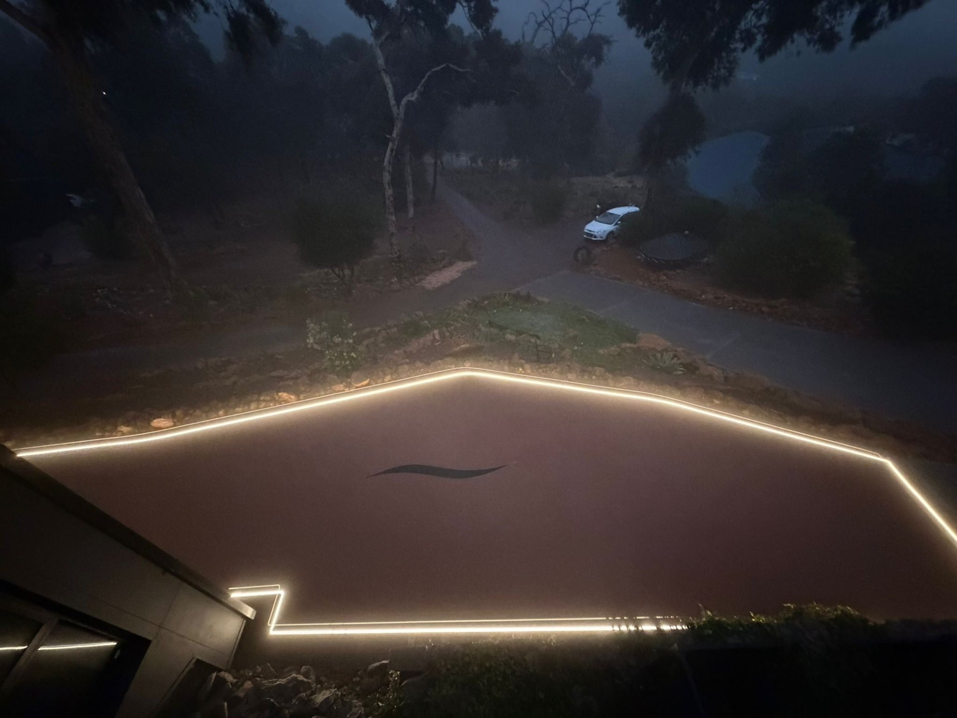LED-lit resin driveway at dusk