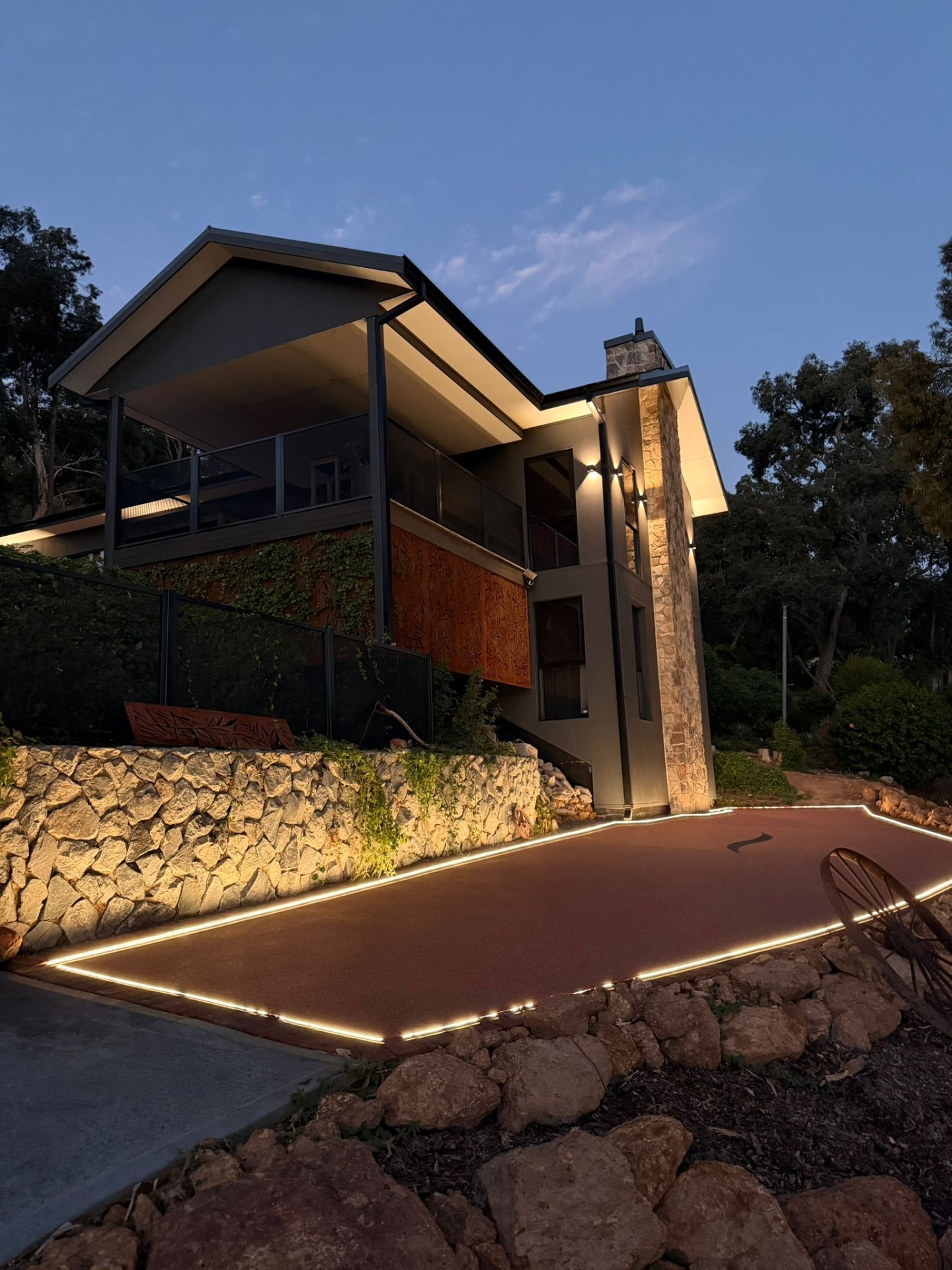 Lit resin pathway with house at twilight