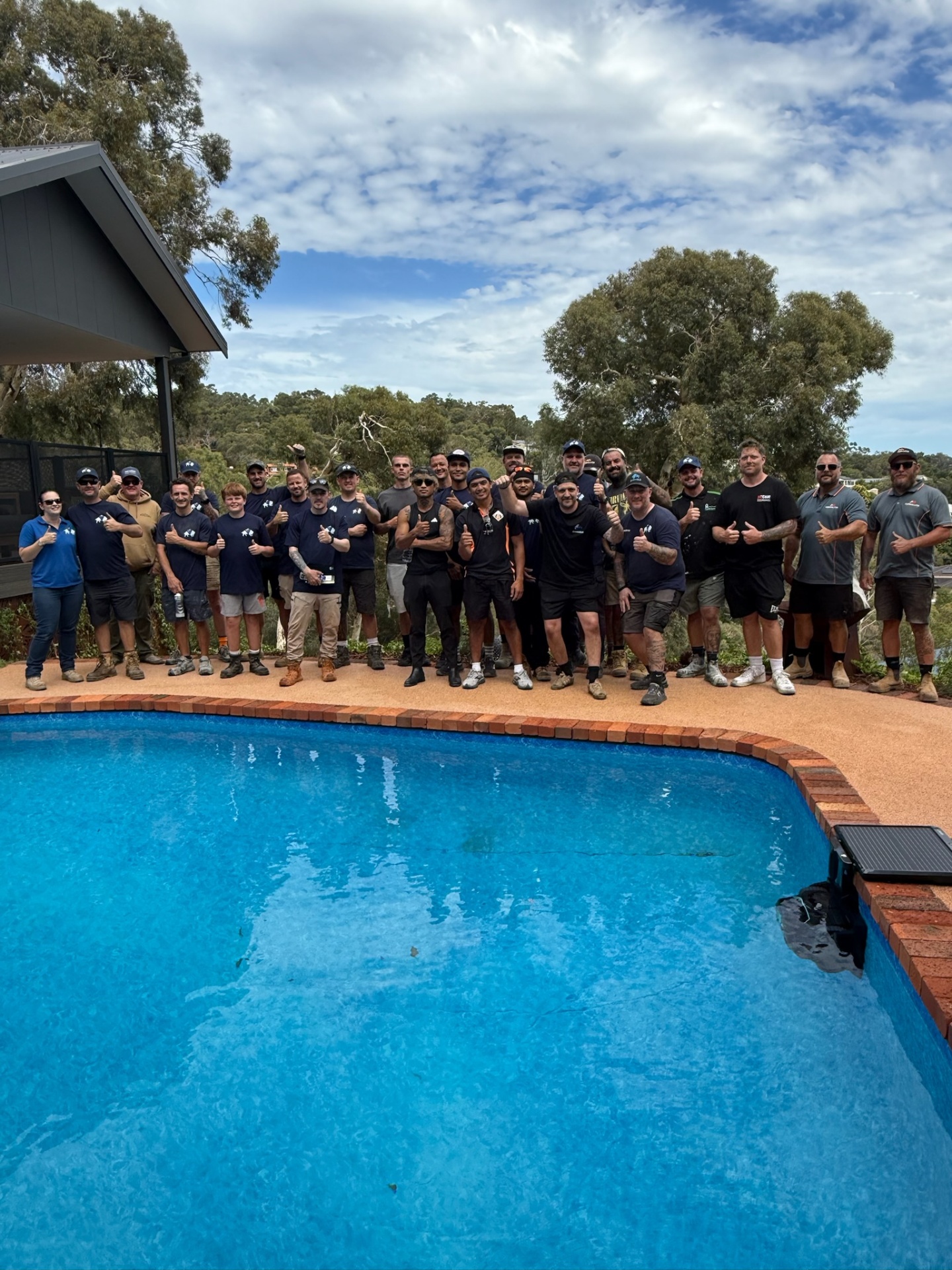 Full training group photo by the pool