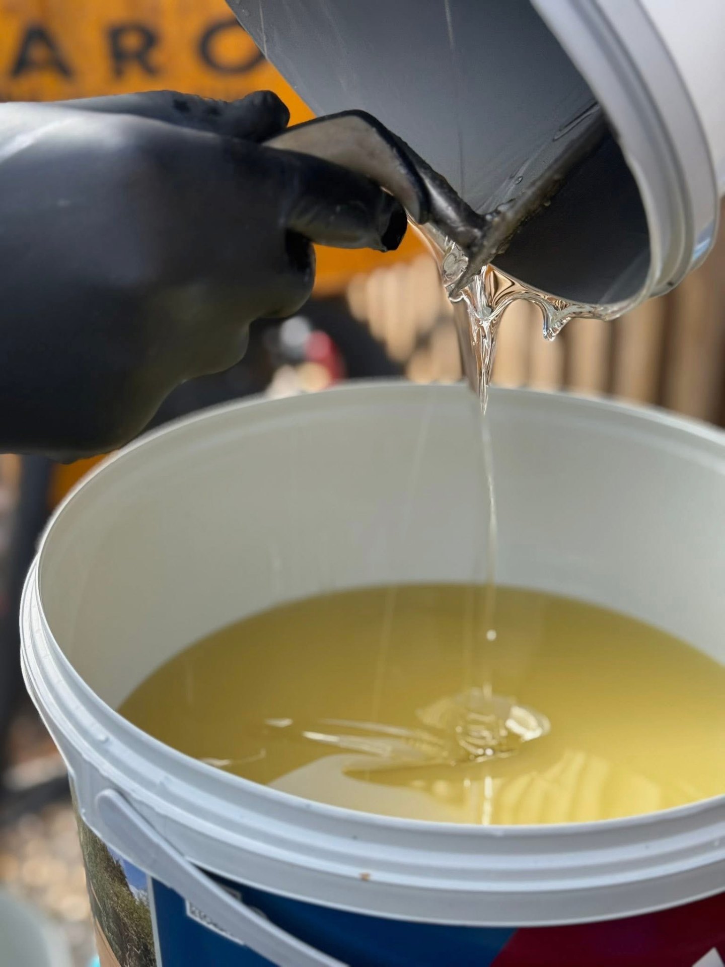 Pouring resin binder into mixing bucket