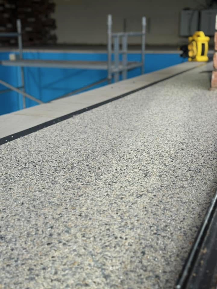 Resin bound surface along pool edge coping