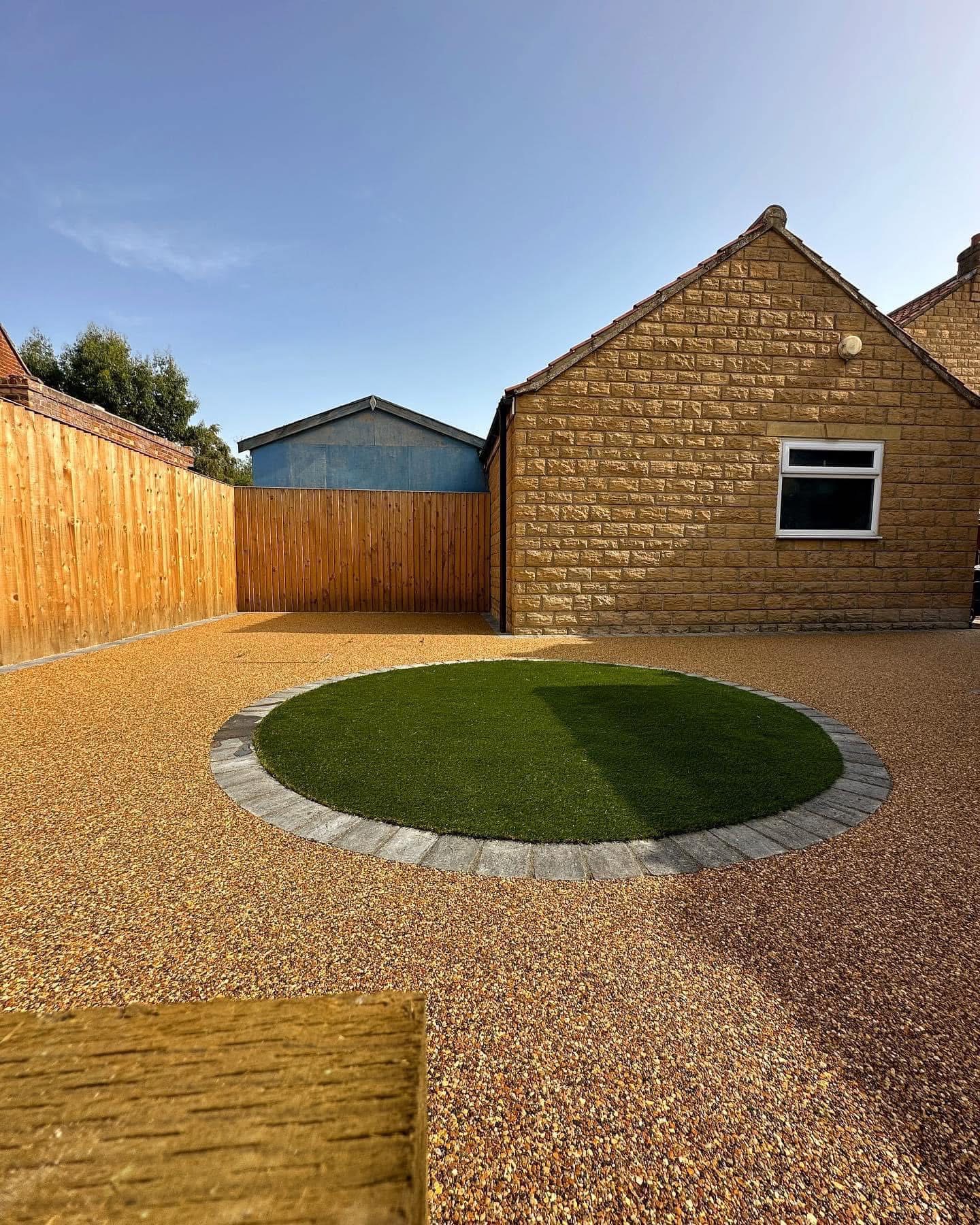 Backyard with resin bound surface and artificial grass circle