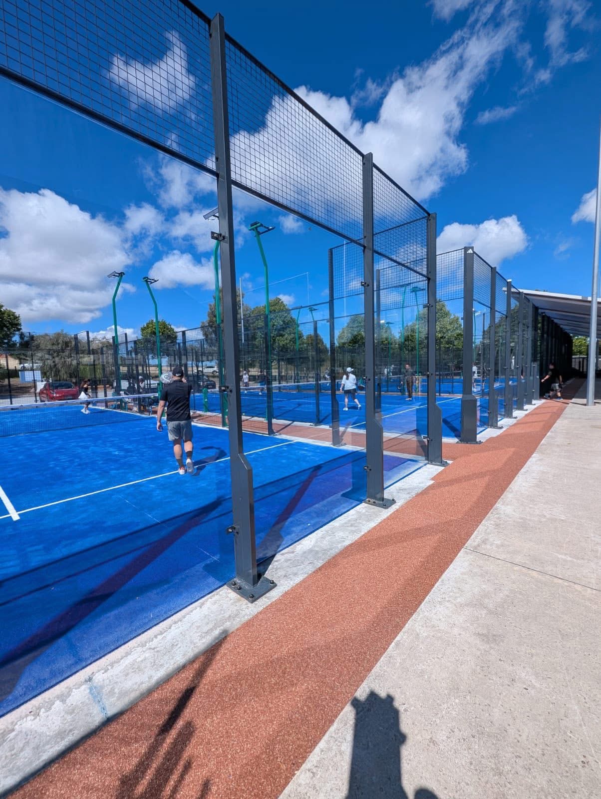 Blue padel tennis courts with resin bound surround