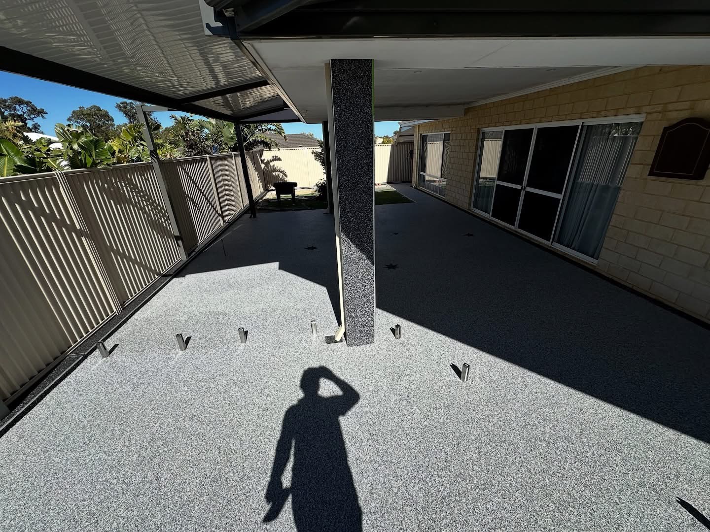 Large covered outdoor area with grey resin bound surface