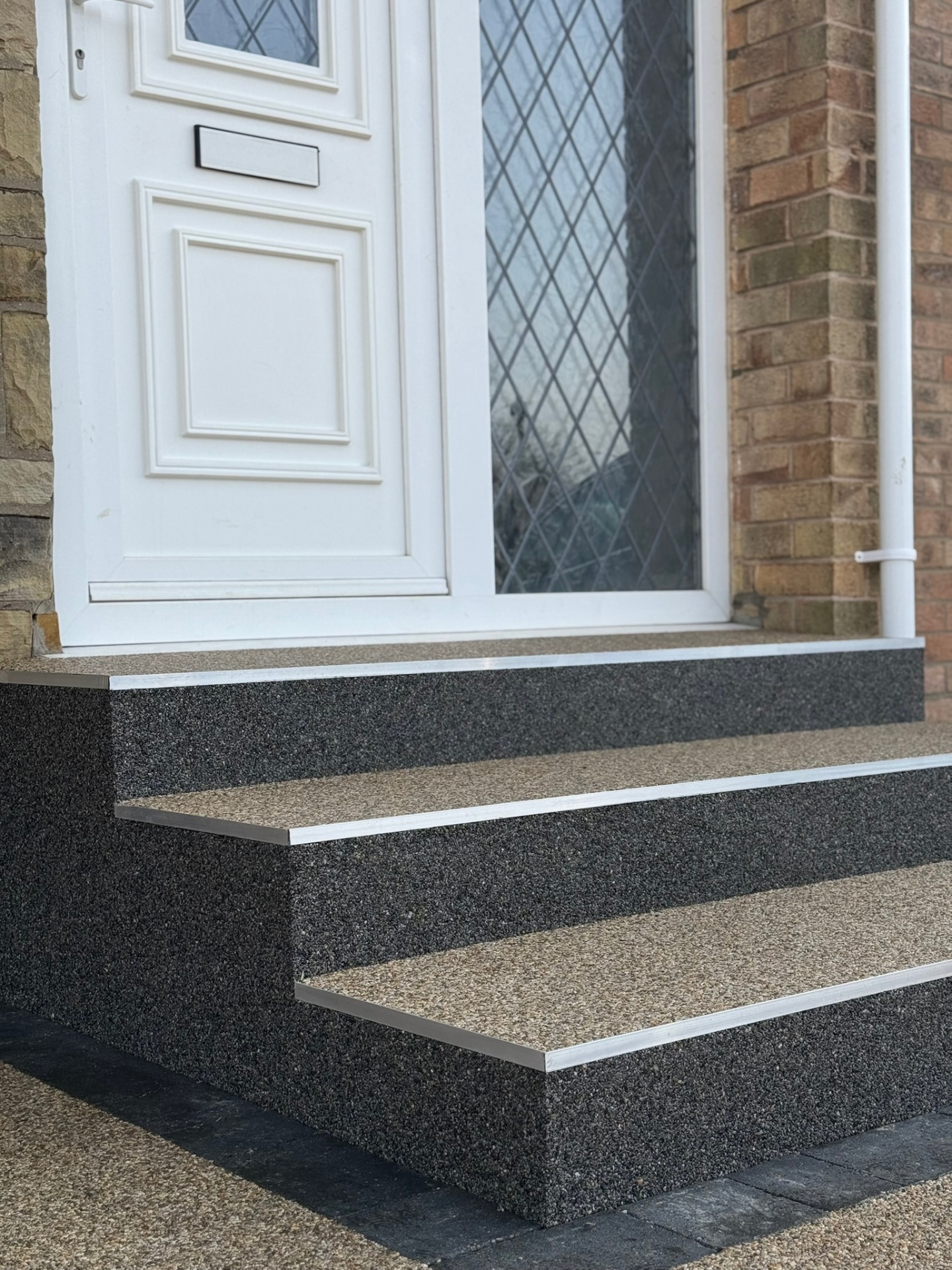 Dark grey resin bound front door steps with silver trim