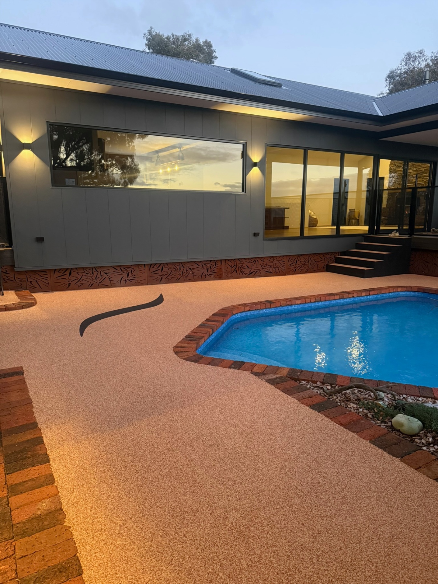 Resin bound pool area with modern home
