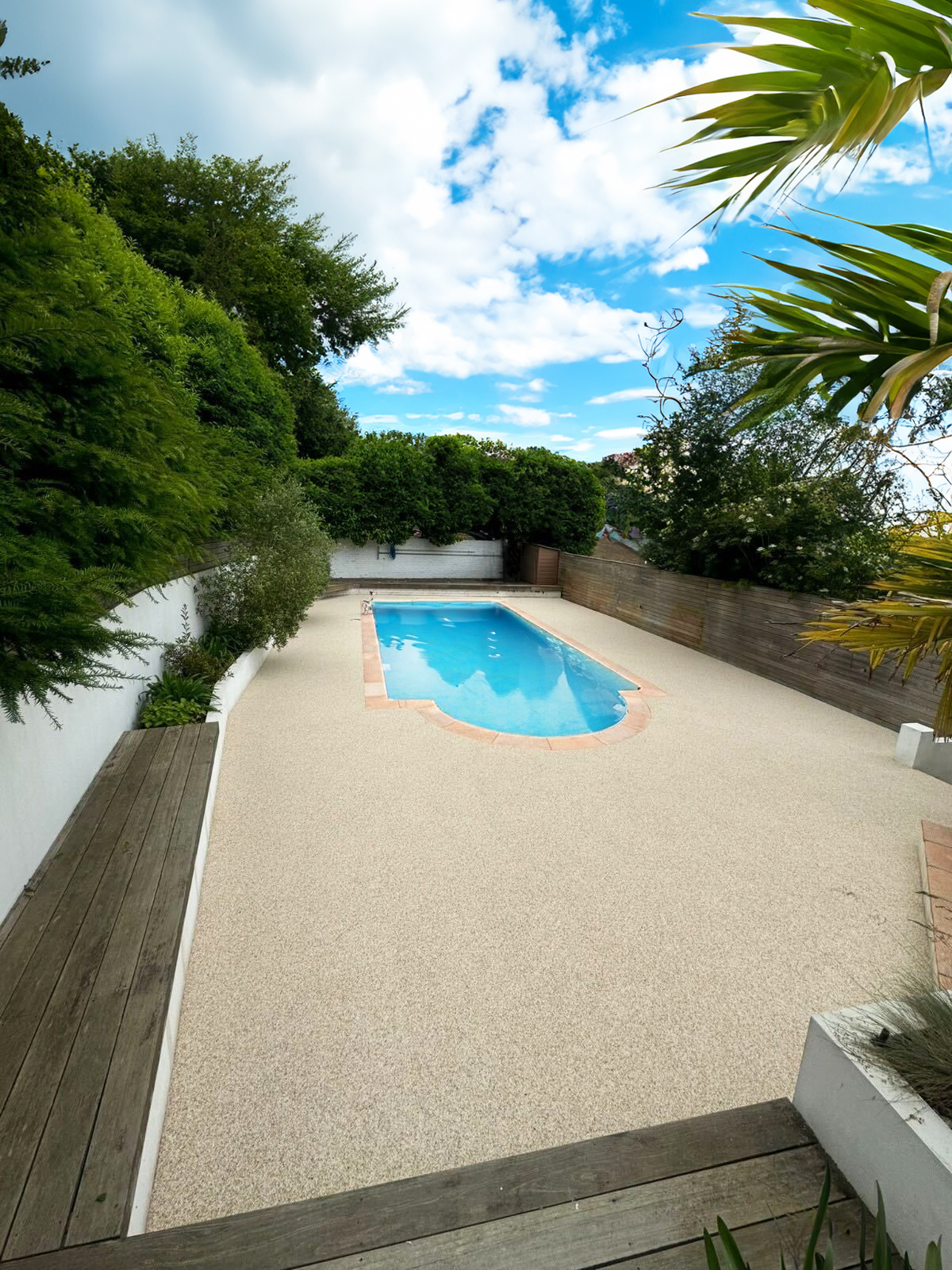 Resin bound pool deck with tropical garden landscaping