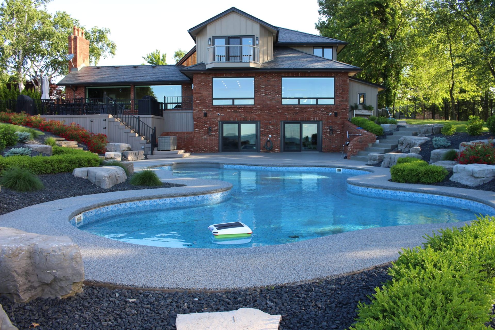 Resin bound freeform pool surround with luxury home