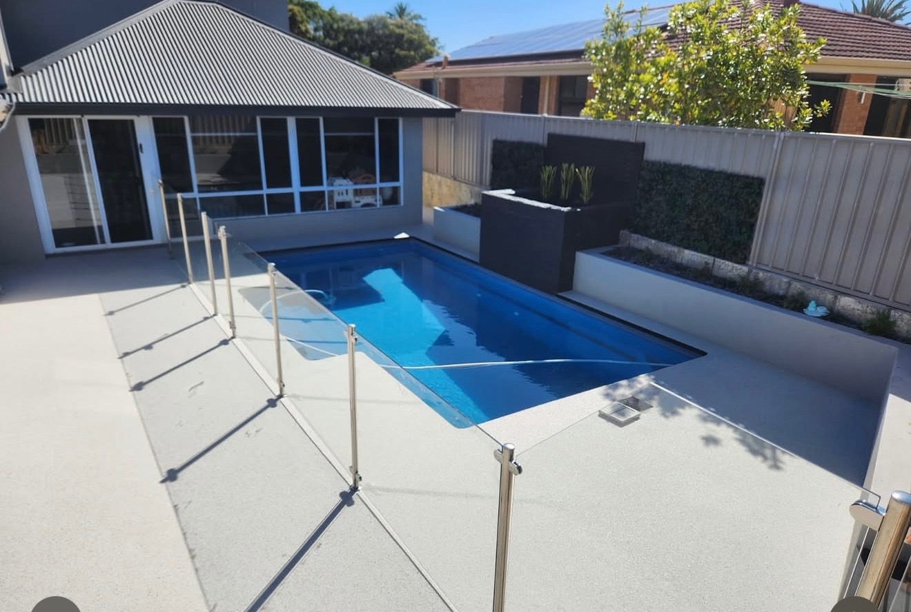 Resin bound pool surround with glass fencing