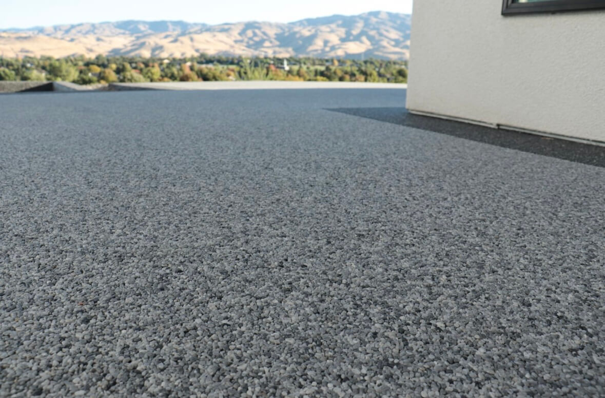 Resin bound terrace with mountain views and dark aggregate finish
