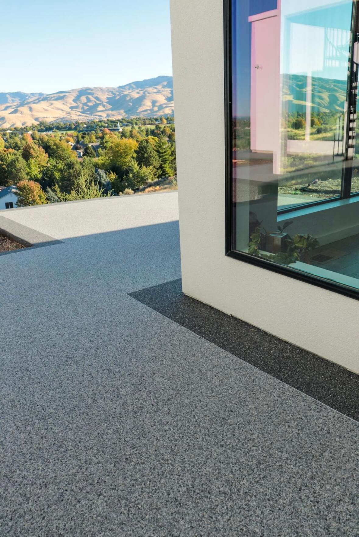 Resin bound balcony with hillside valley views and modern glazing