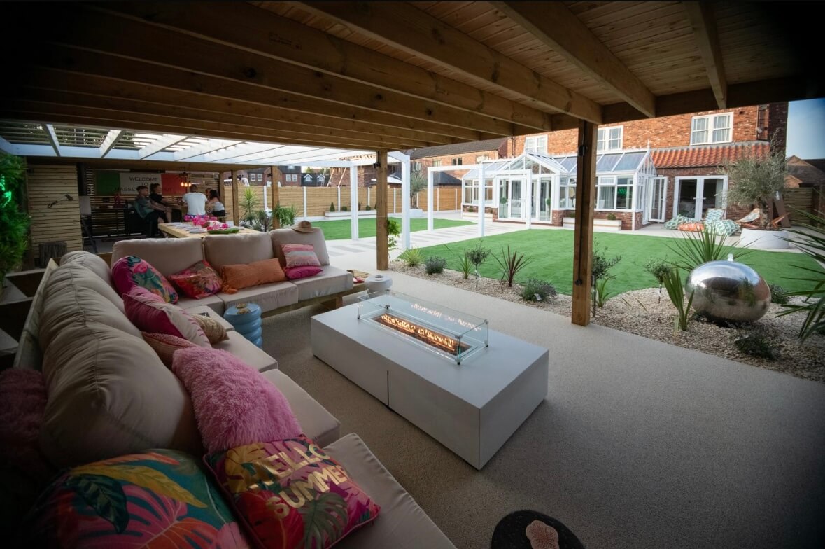 Resin bound outdoor living area with pergola, fire pit and landscaped garden
