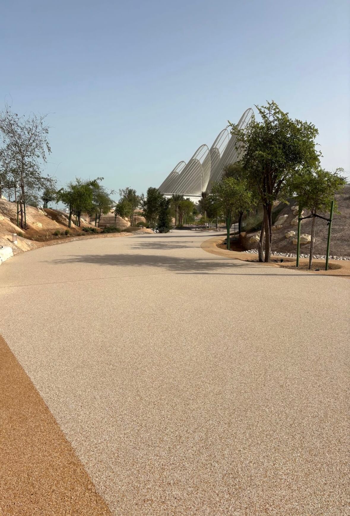 Resin bound commercial pathway with modern architectural landmark