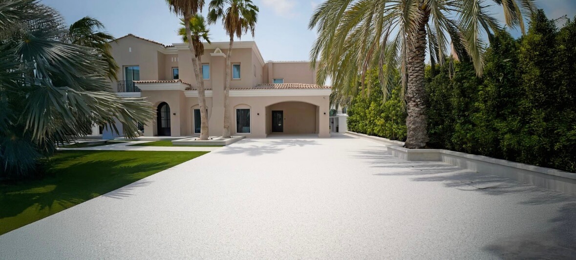 Resin bound white driveway with luxury villa and palm trees
