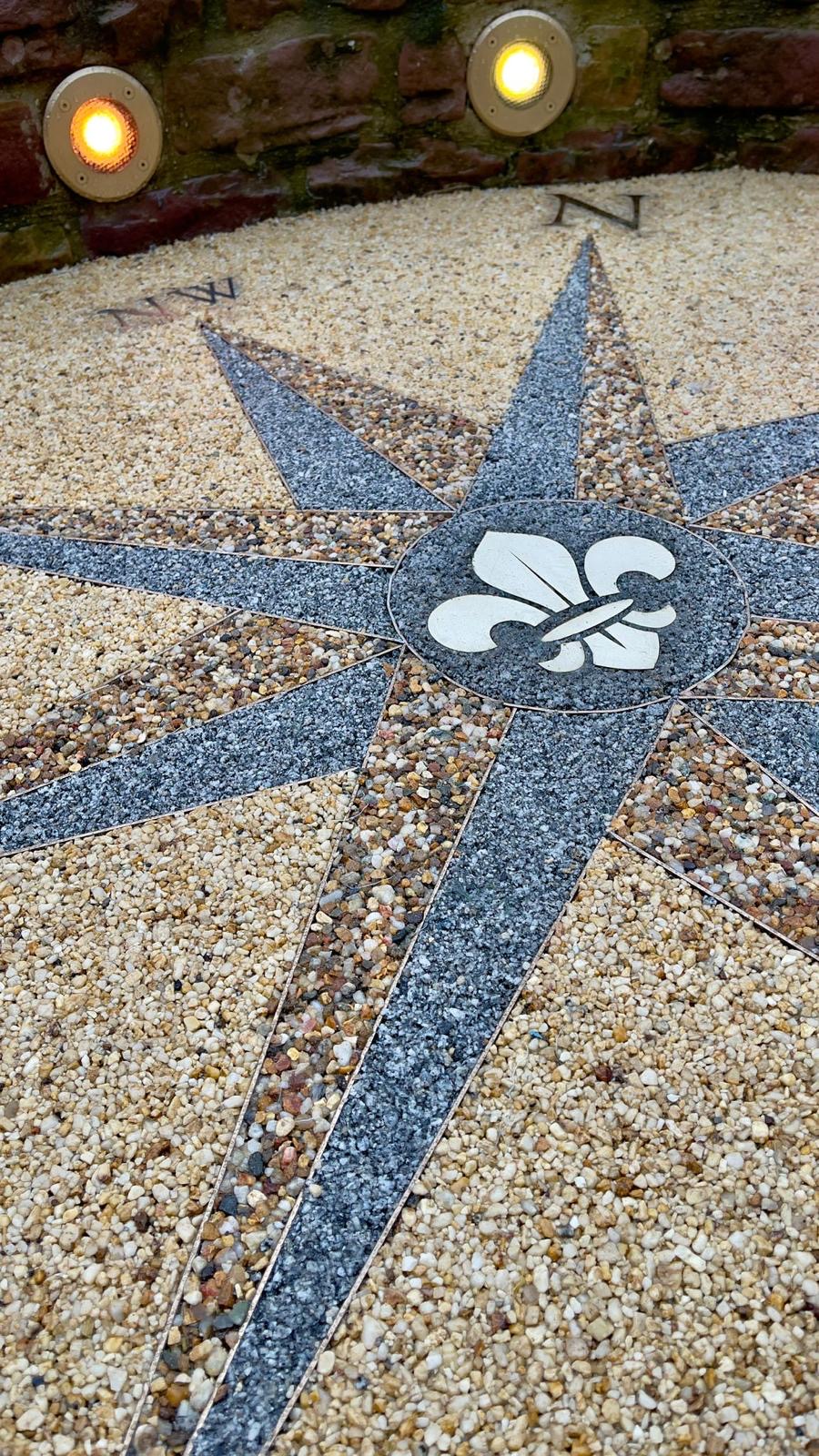 Resin bound compass rose design with fleur-de-lis centre detail
