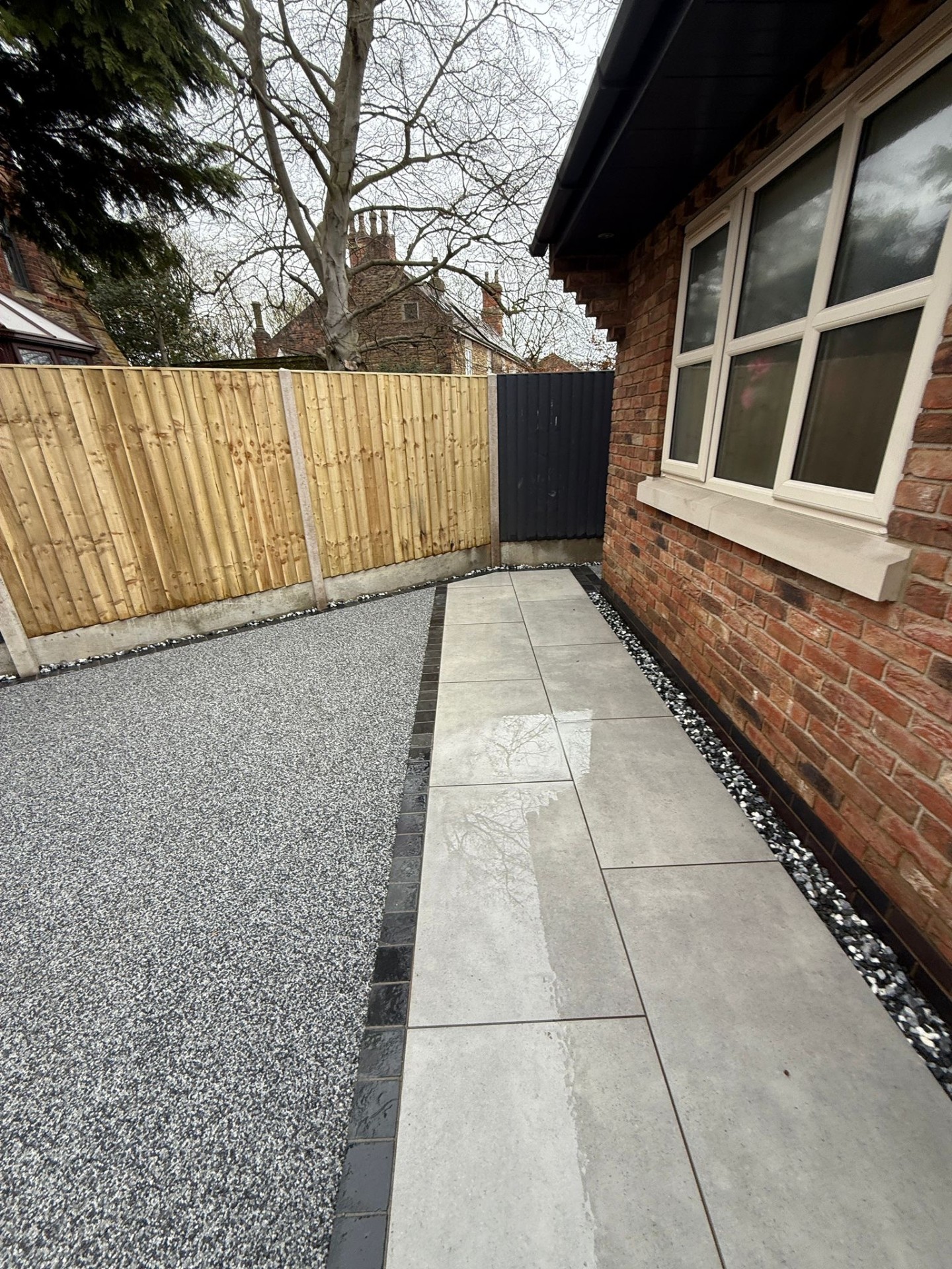 Resin bound side pathway with paving slabs and brick house