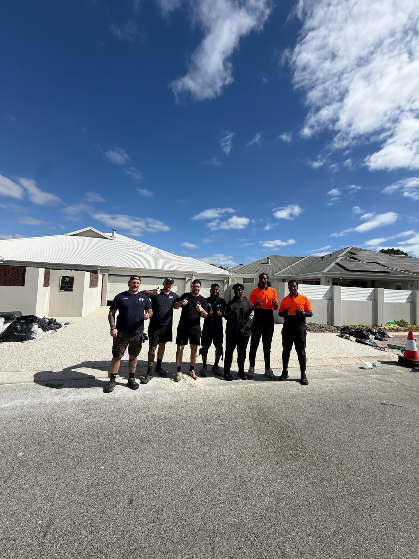Vuba Surfaces WA installation team on completed resin driveway Perth