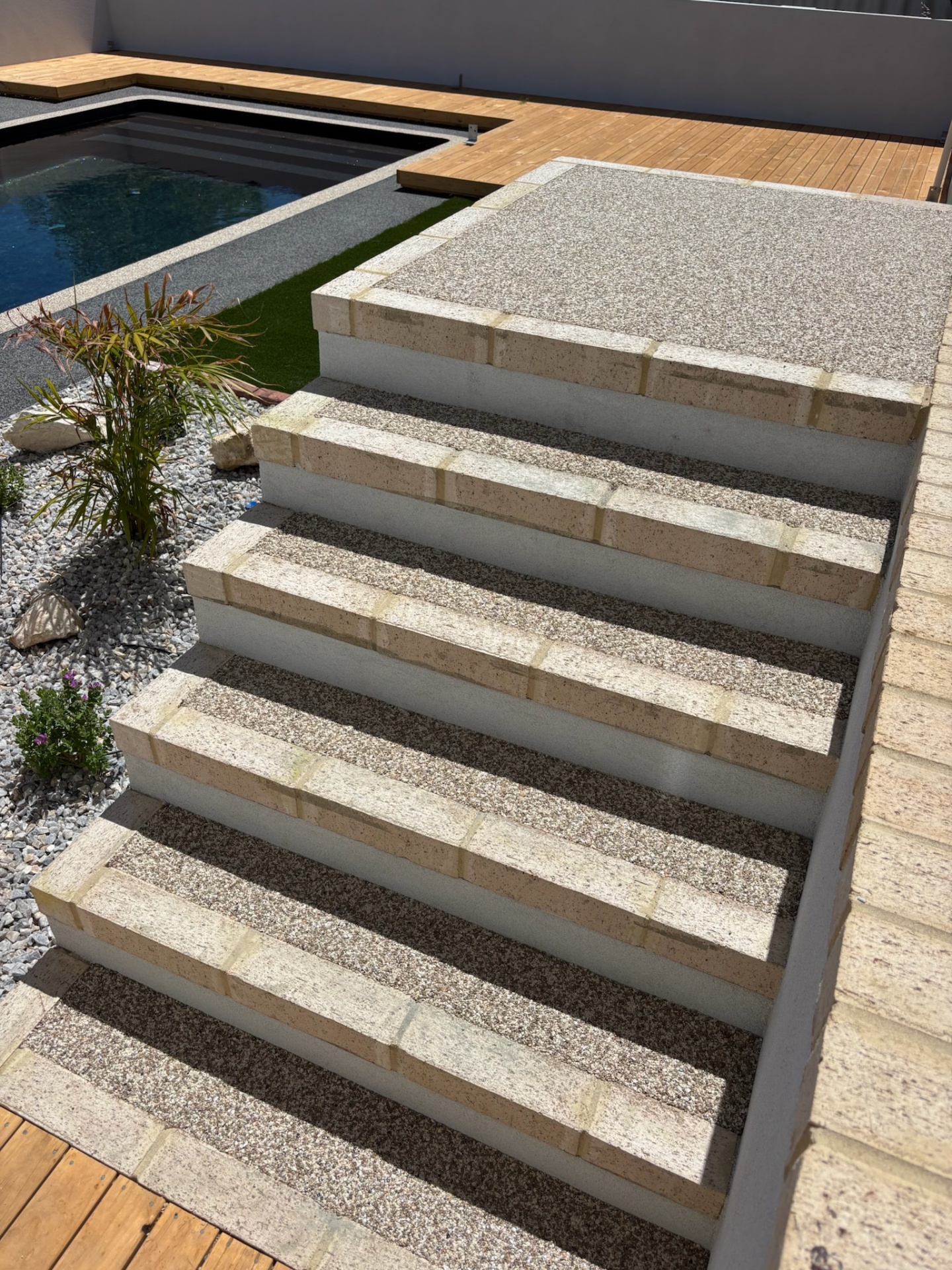 Resin bound pool steps Perth with limestone block risers
