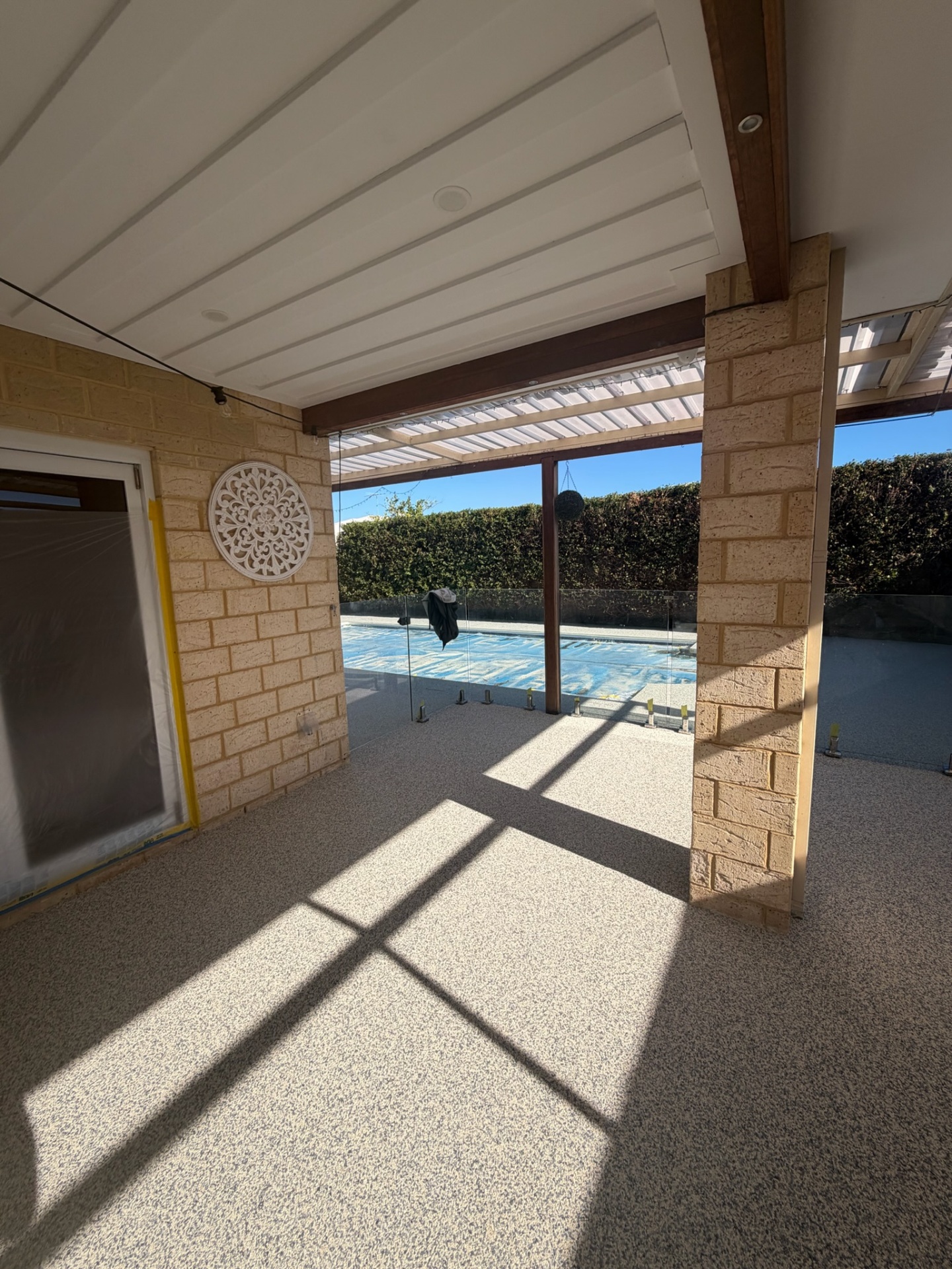 Resin bound undercover patio Perth with pool view