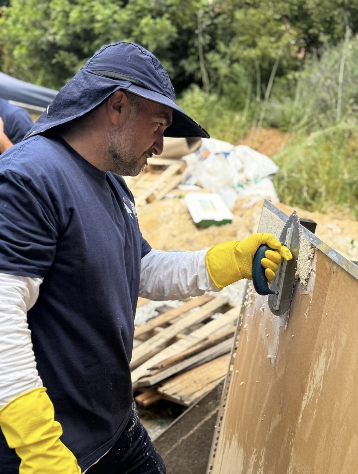 Installer practising vertical trowel technique